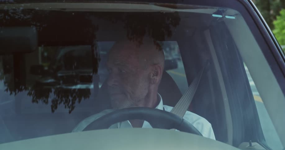 Man parking his car in a space and getting out of the vehicle