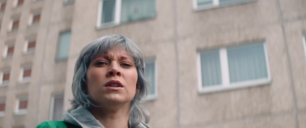 A woman screams in front of the building
