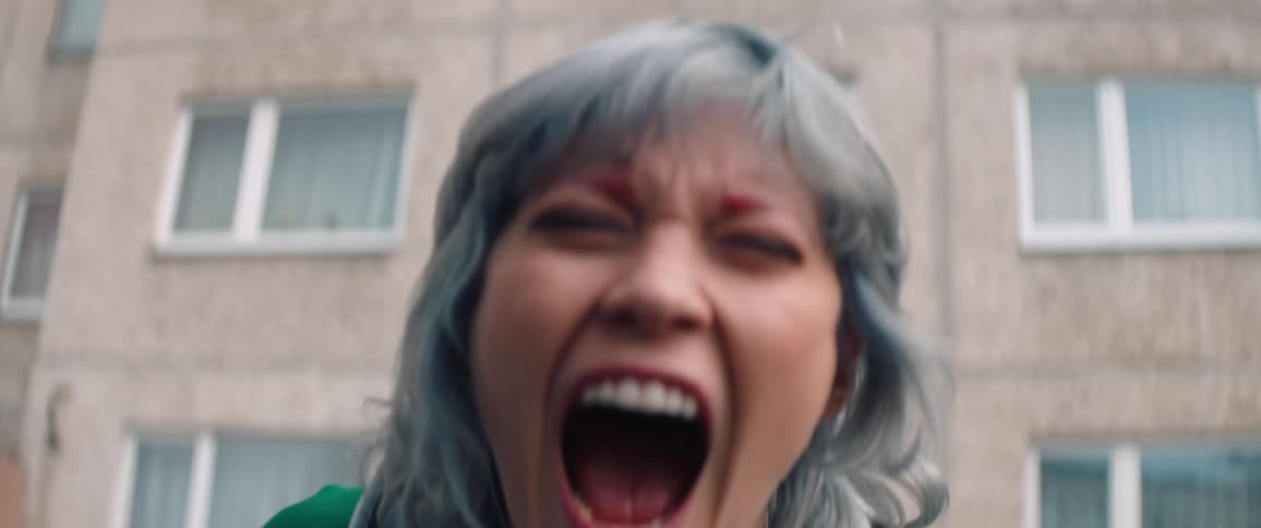 Portrait of a woman in an outdoor setting screaming intensely