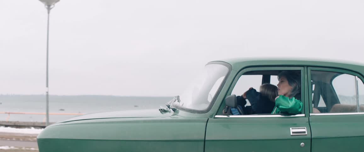 Two women laugh while riding in a car