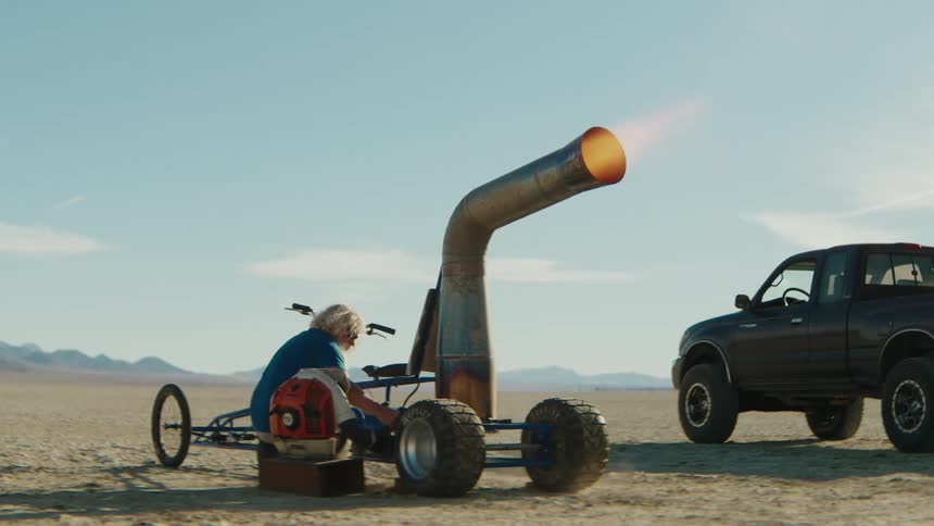 A person starting a jetpowered gokart emitting plumes of flame in the desert