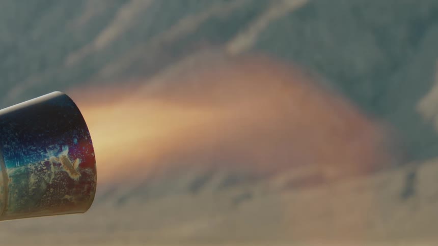 Close up of flames emerging from the exhaust of a jet powered go kart in the desert