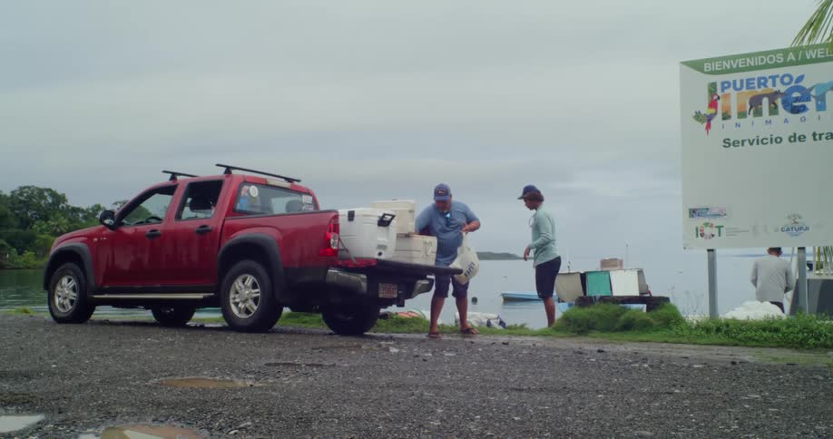 People load supplies out of coolers on the truck
