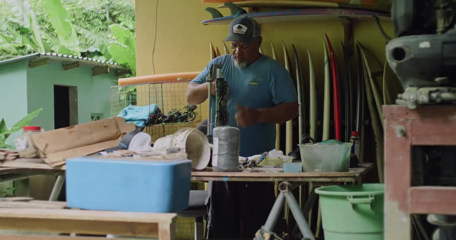 A man is working in his outdoor workshop