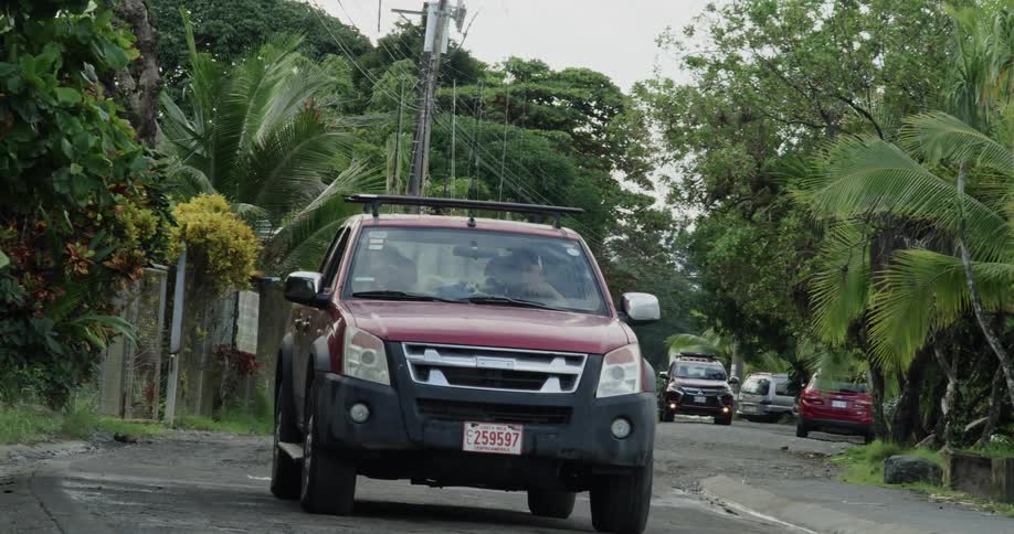A car drives down the bumpy road full of pot holes