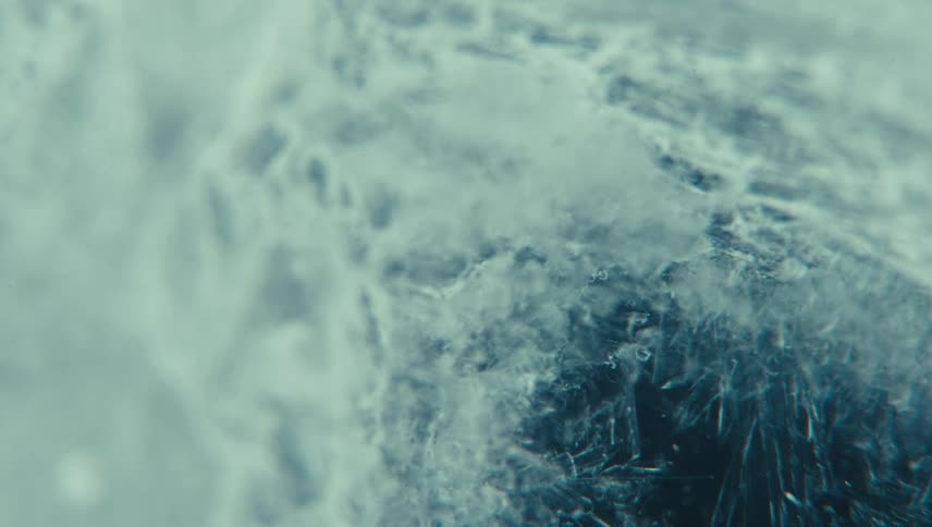 Ice formation with detailed textures accompanied by small shiny particles