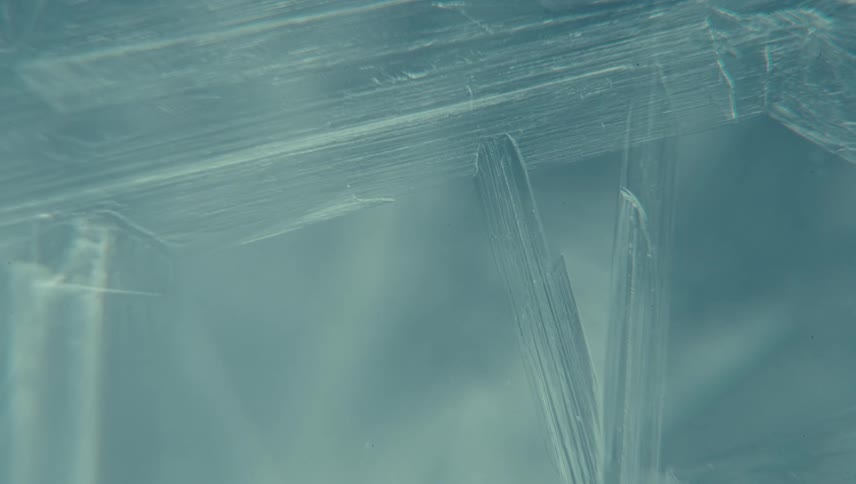 Closeup of translucent ice crystals forming lines and shapes