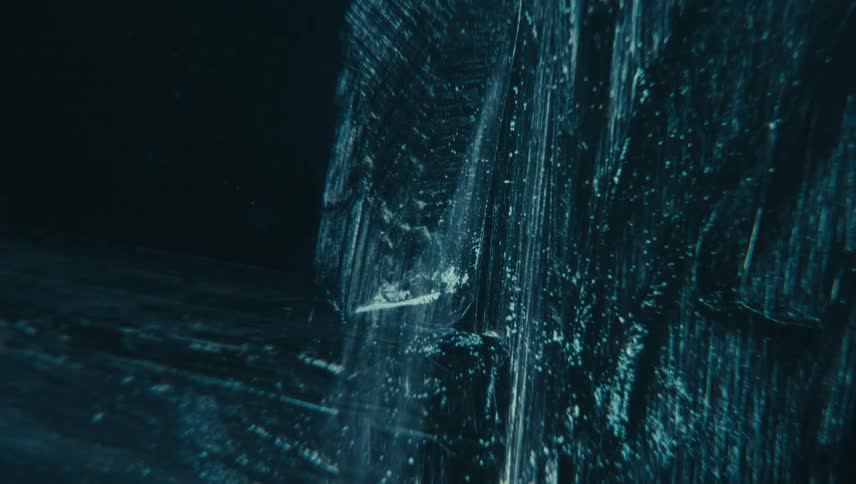 Ice texture with sharp details and scattered freezing particles