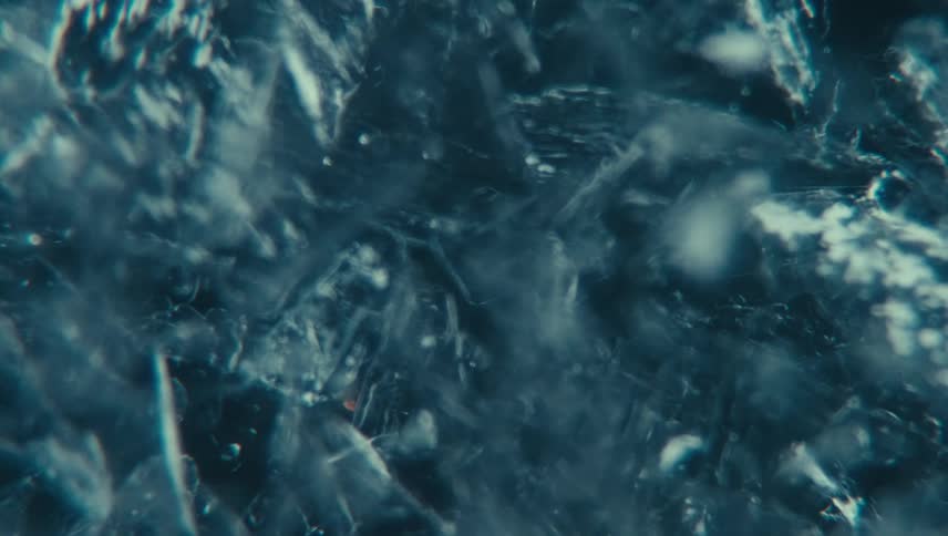 Extreme close up of swirling water with ice particles