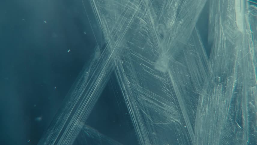 Ice crystals with thin lines and angular features freezing the water