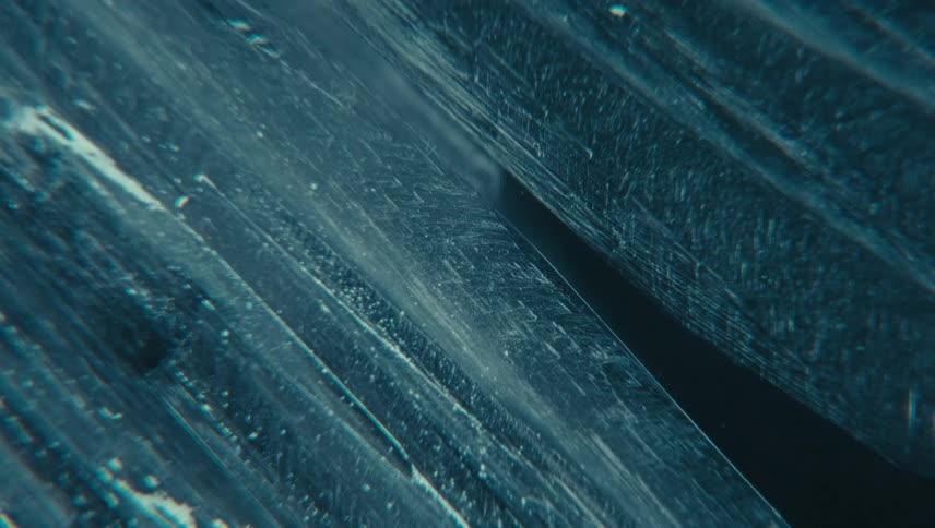 Blue frosting with a textured surface displaying intricate lines patterns and small scattered dots