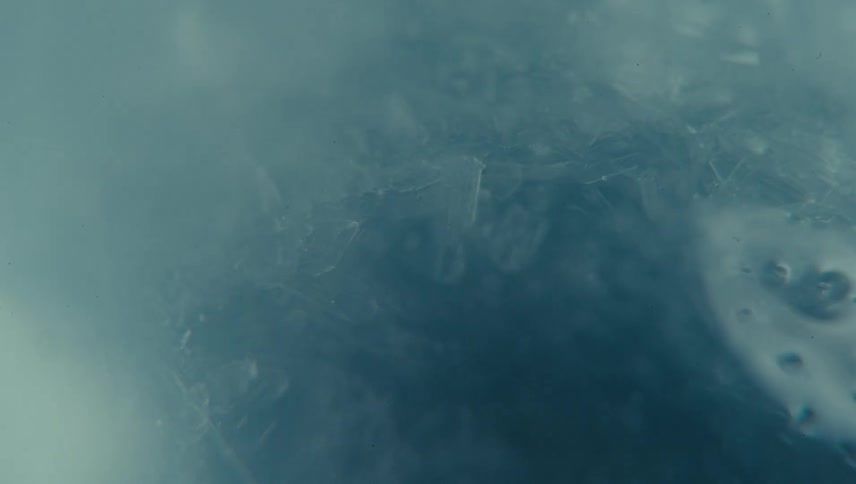A frosty surface intricate and icy with a hazy bluish atmosphere conveying a sense of cold serenity