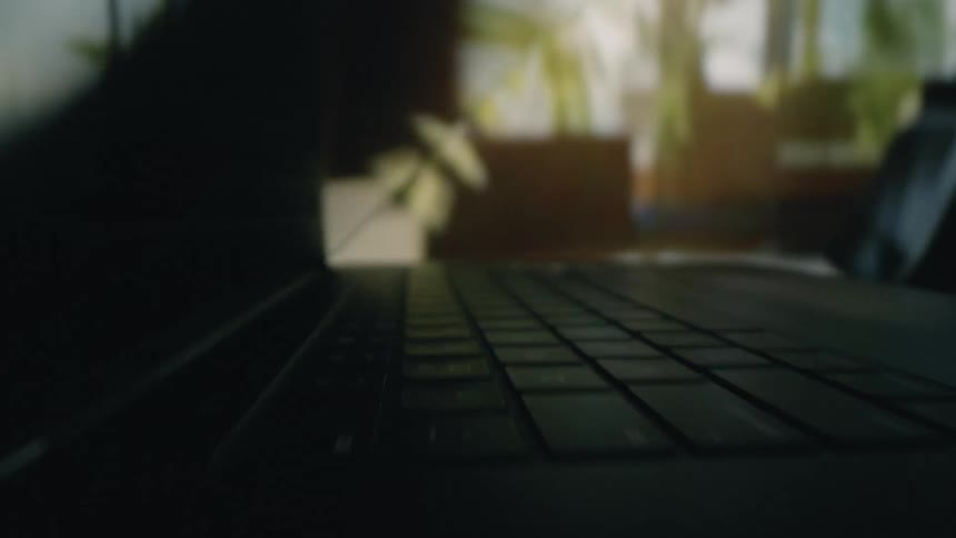 Man touches keyboard then closes laptop before opening the computer touching more keys and closing it again