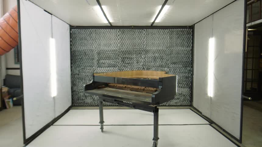 Disassembled piano in a welllit workshop environment