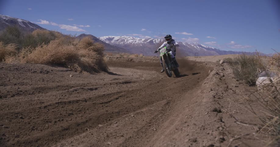Motorcyclist taking a curve at high speed on a dirt track