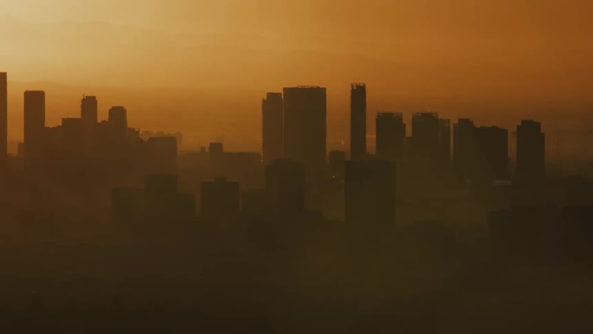The downtown Los Angeles skyline is covered by haze and smoke from the Los Angeles fires