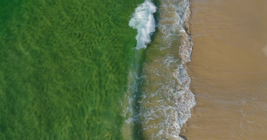Ocean waves slowly wash up on the shore