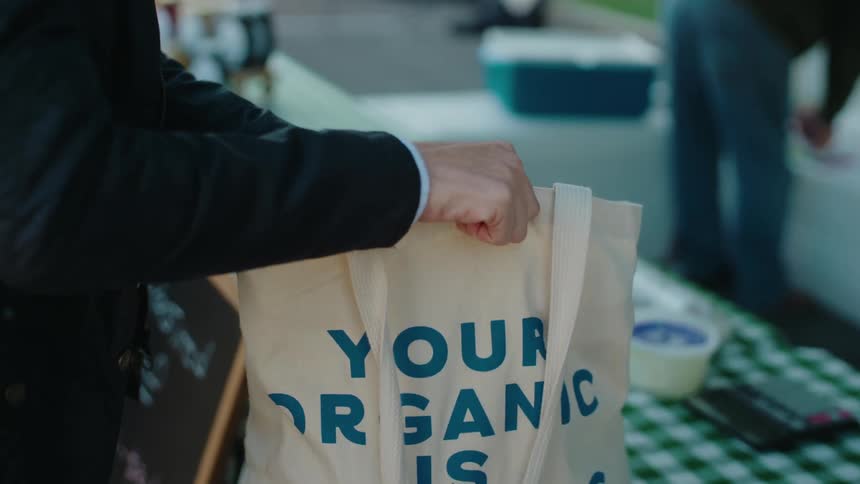 Hands of a woman putting products inside a bag
