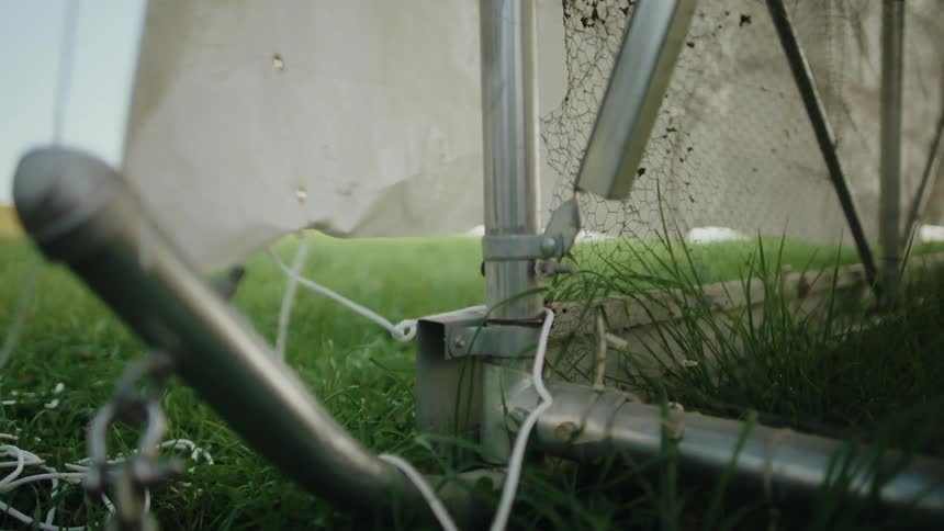 Person adjusting the metal frame of a wire mesh fence