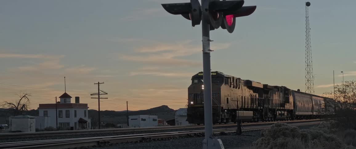 A freight train is moving down a track in a town
