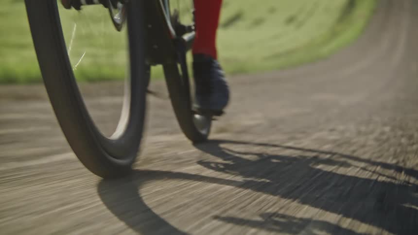 A person is riding a bike on a dirt path