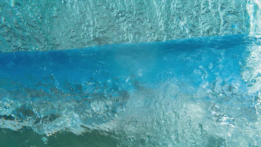 A large wave is crashing near the shore