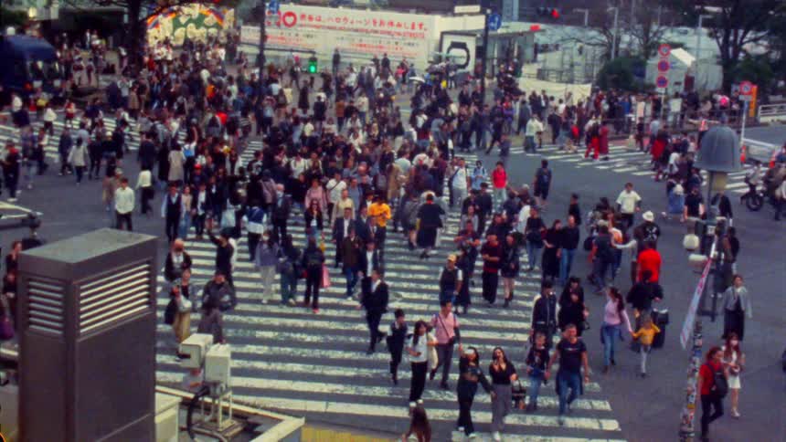 The iconic shibuya scramble crossing in tokyo with a crowd crossing the street in all directions
