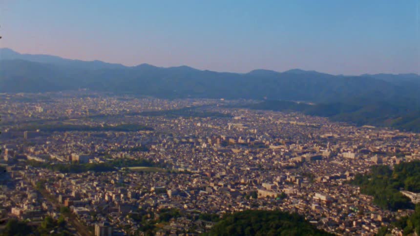 A large city is seen from the mountains