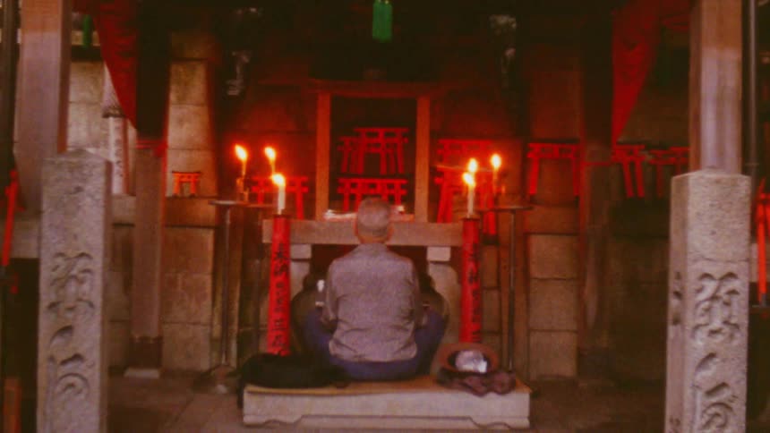 A man is praying at an altar in a shrine