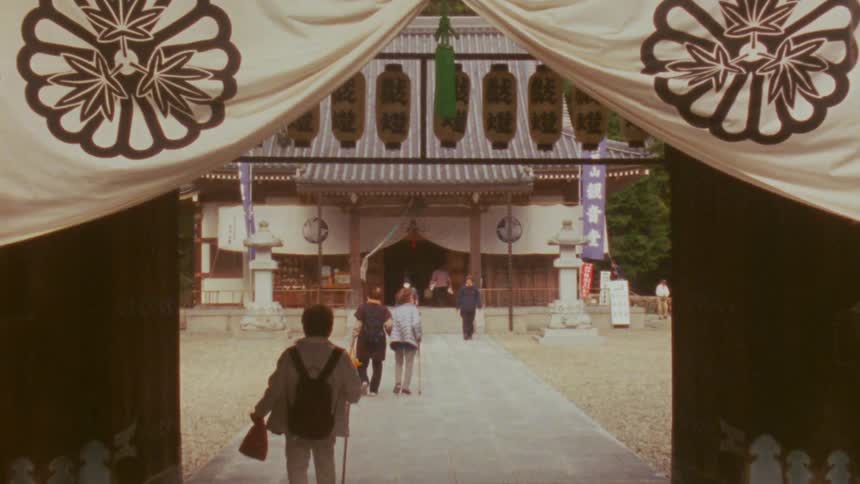 People make their way in and out of a temple