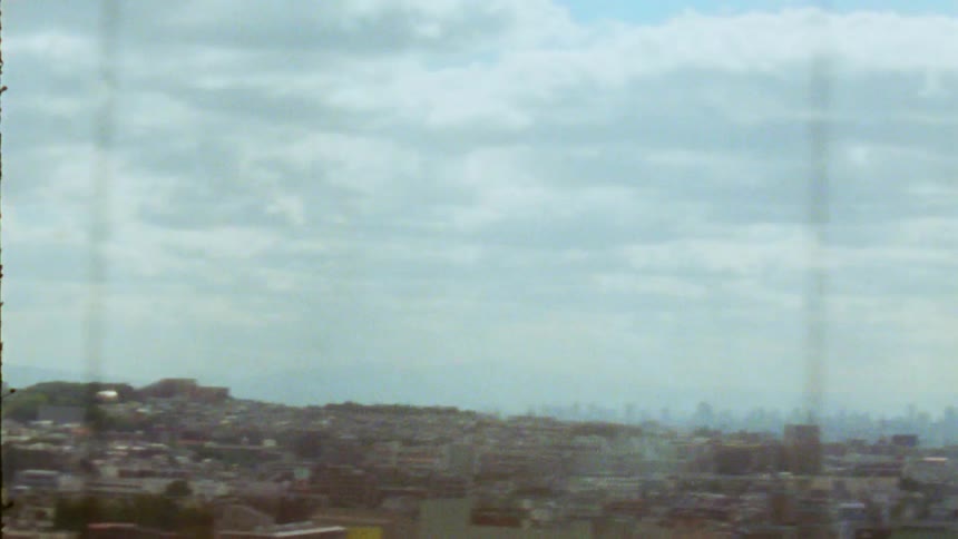 An urban landscape with densely packed buildings viewed from a descending elevator