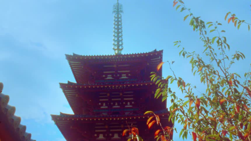 A multitiered pagoda with intricate architectural details set against a clear blue sky