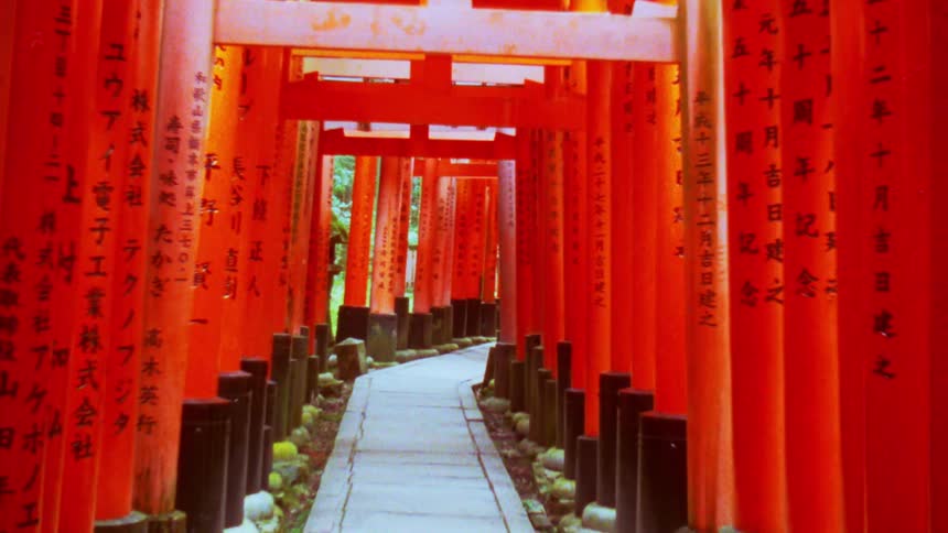 Red decorations with writing on them line a walkway outside
