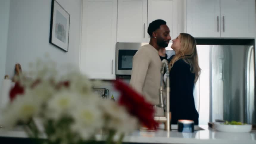 Happy couple kissing in the kitchen