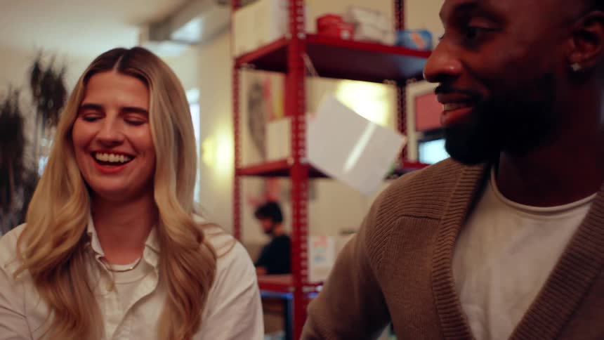 Couple meets a friend at a cafe for coffee