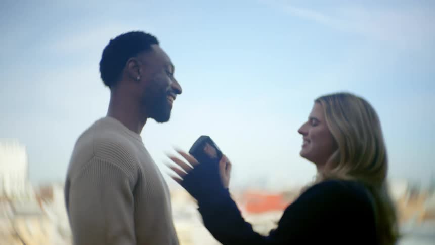A couple laugh as they photograph each other