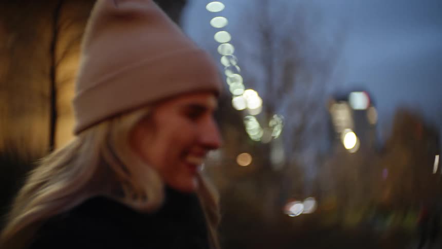 A young happy couple laughing and smiling in the city at dusk