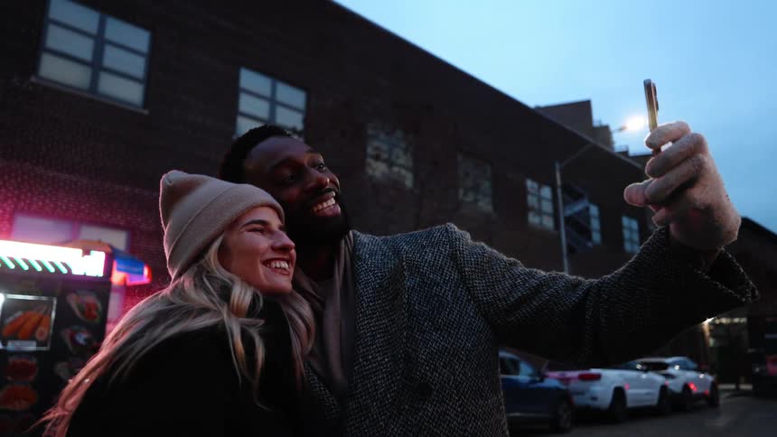 A man takes a selfie with a woman