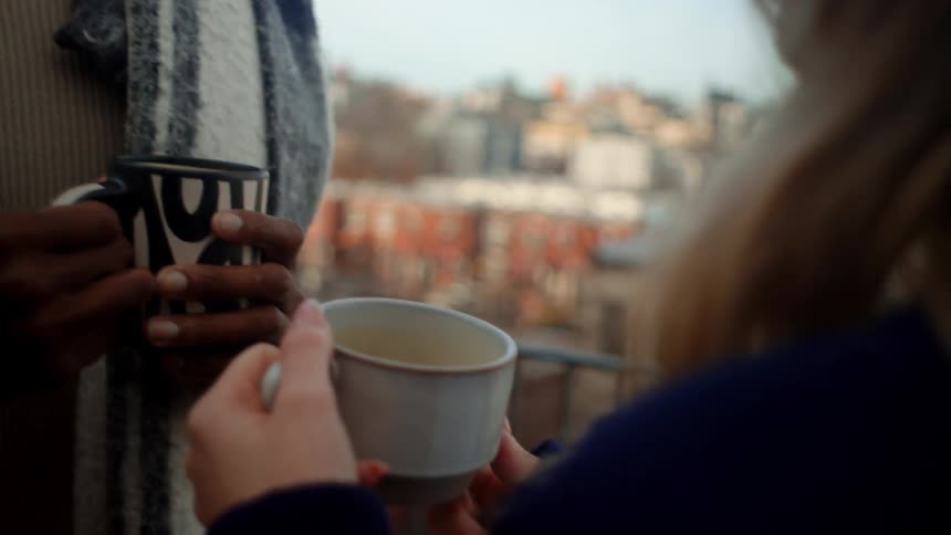 Man and woman holding mugs