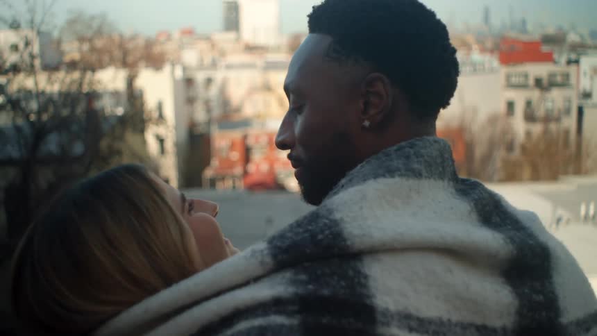 Man and woman cuddling together on a blanket