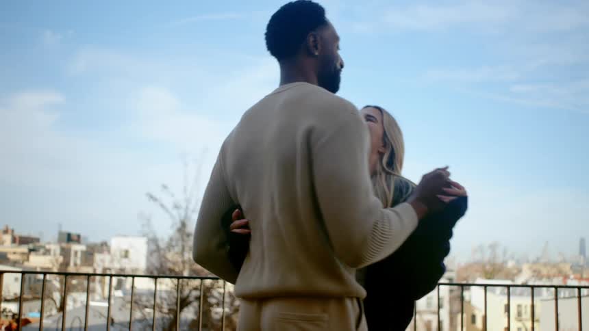 Woman and man hugging each other happily