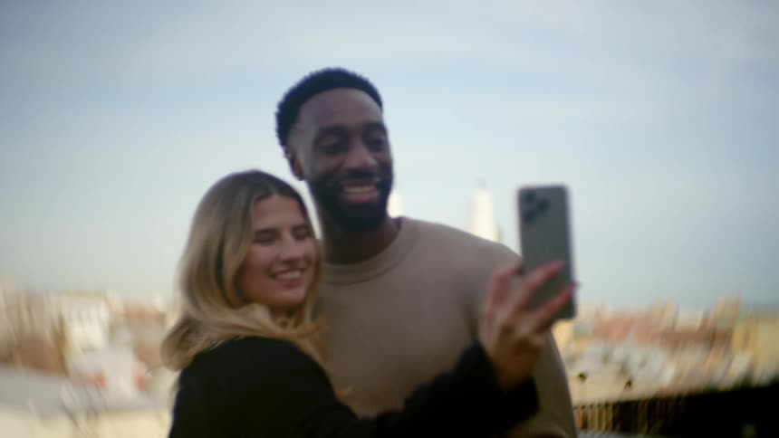 A couple take a selfie then kiss