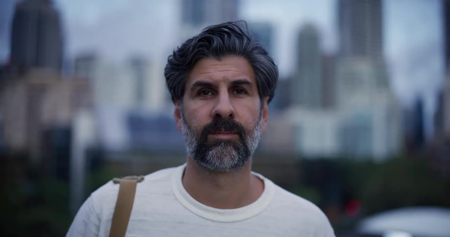 A man is standing before a large city