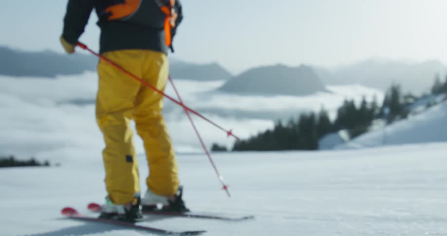 People wearing protective gear skiing downhill on the snow outdoors during day time