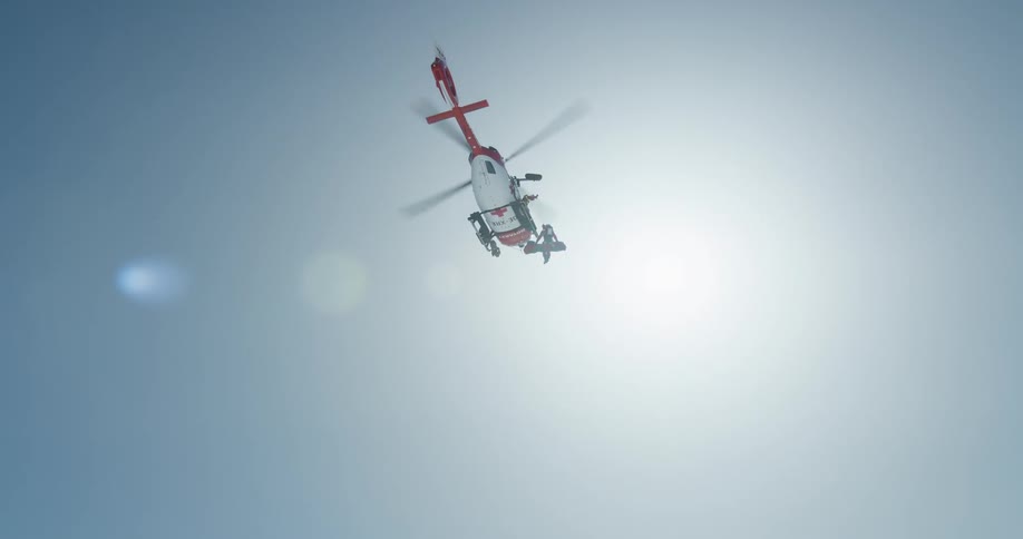 Upward view of a rescue helicopter flying in the sky