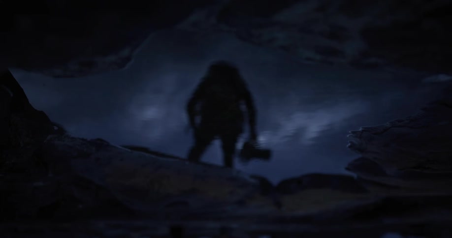 The puddle on the rocks shows a man running over the rocks