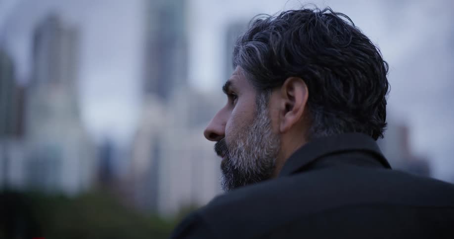 A man looks at the skyline in front of him