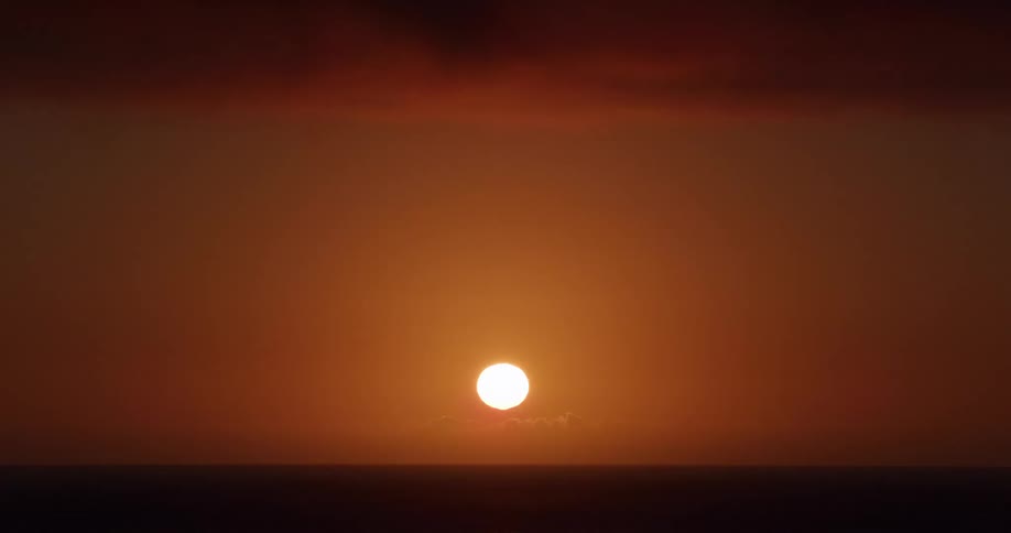 The sky is red as the sun rises
