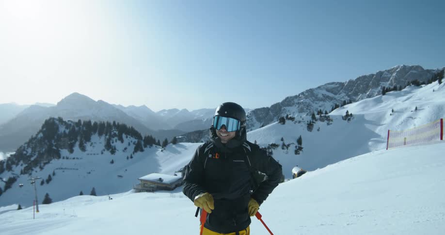 Person with sports goggles and ski equipment on a snowy mountain