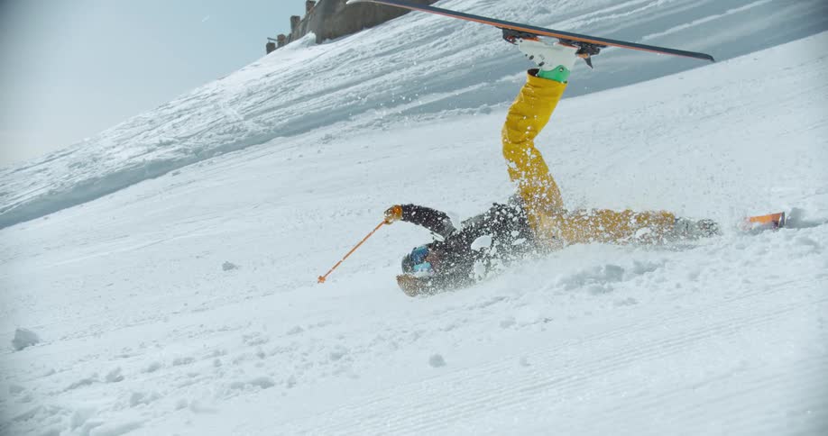 Person doing a ski maneuver in the snow and falling